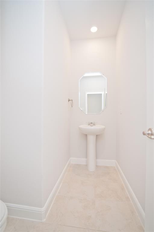 1021 Gillespie Drive Fort Worth, TX 76247 - Photo 5 of 38 a bathroom with a sink a toilet and a mirror