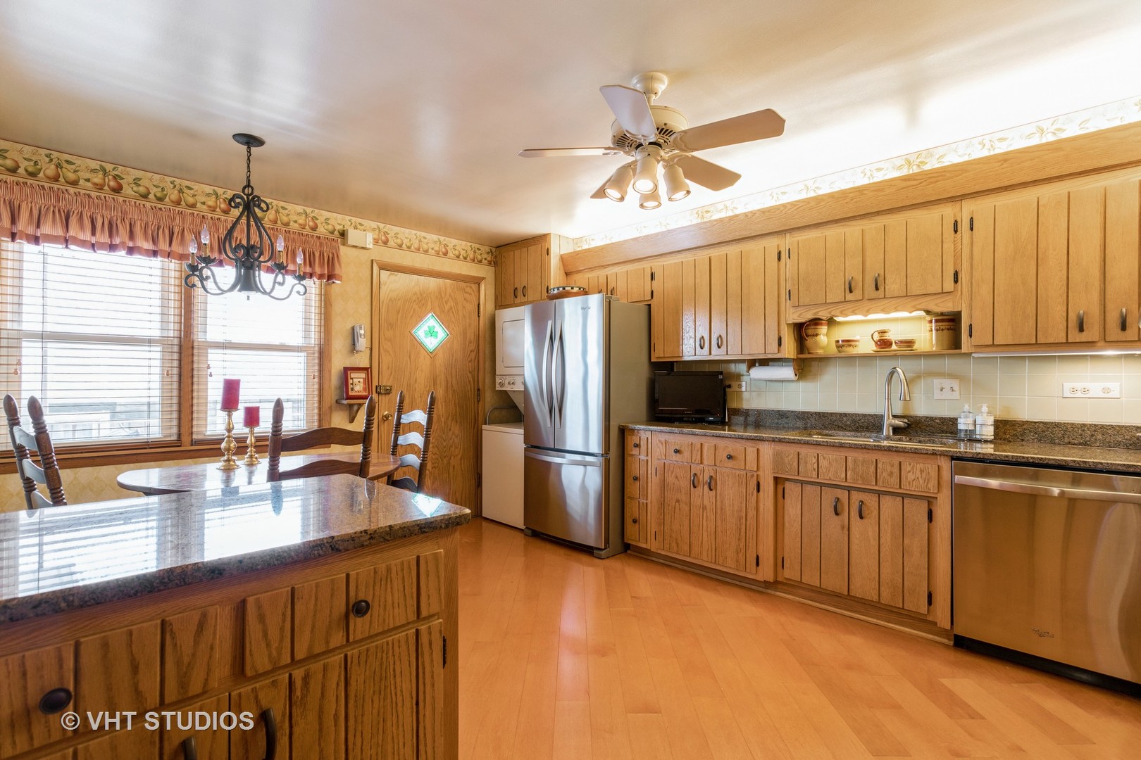 4545 North Long Avenue, Unit 3D Chicago, IL 60630 - Photo 7 of 19 a kitchen with stainless steel appliances granite countertop a sink refrigerator and cabinets