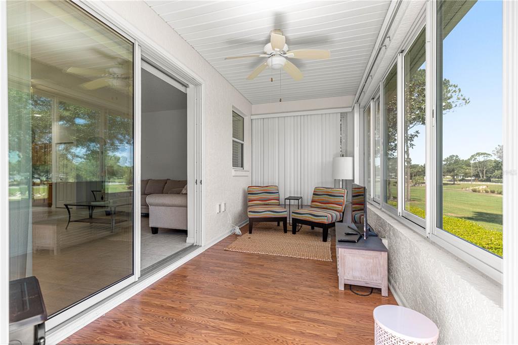 9317 Southwest 94th Loop Ocala, FL 34481 - Photo 8 of 40 a living room with furniture and a floor to ceiling window
