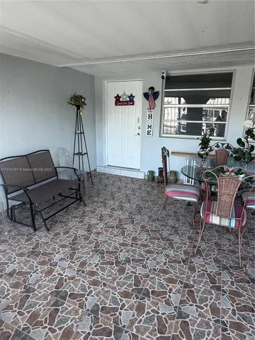 a living room with furniture a window and a table