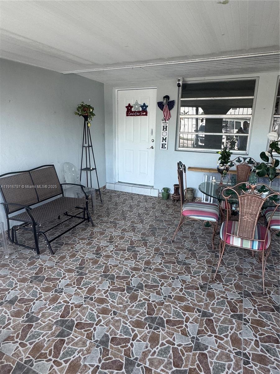 11012 Southwest 4th Street Sweetwater, FL 33174 - Photo 3 of 19 a living room with furniture a window and a table