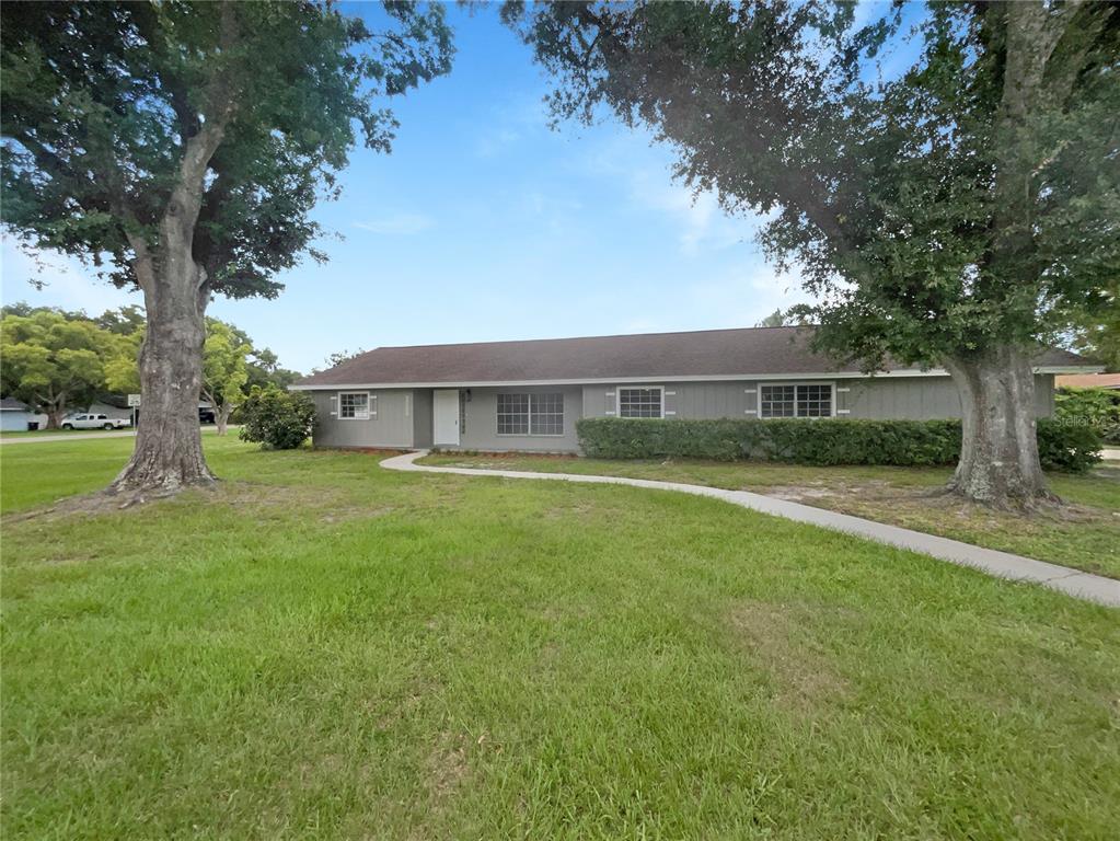 a view of house with a yard