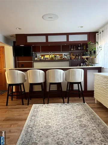 a living room with stainless steel appliances kitchen island granite countertop furniture and a rug
