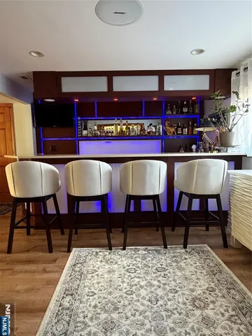 a living room with chairs and rug