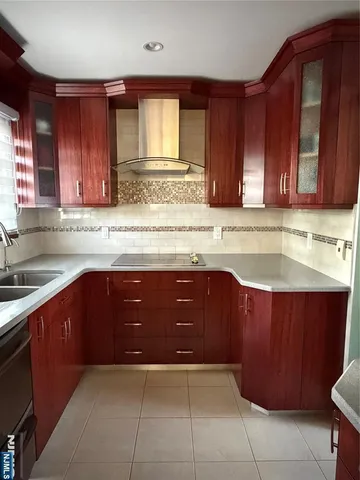 a kitchen with a sink and wooden cabinets