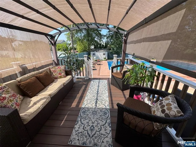 a balcony with furniture and a potted plant