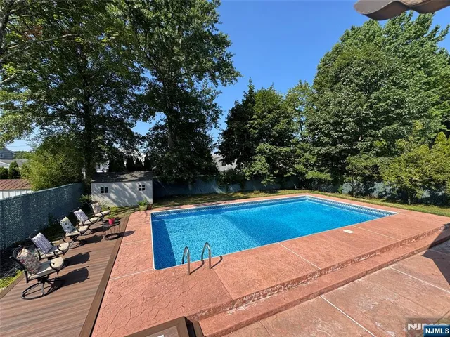 a view of a swimming pool with lounge chairs