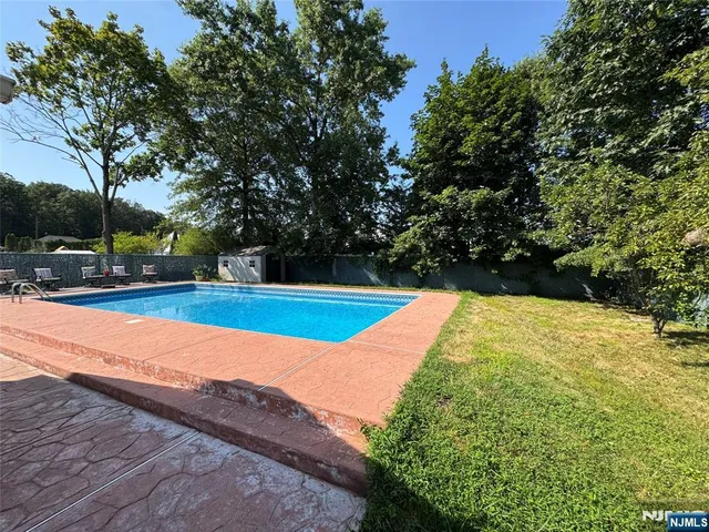a view of swimming pool with an outdoor space and seating area