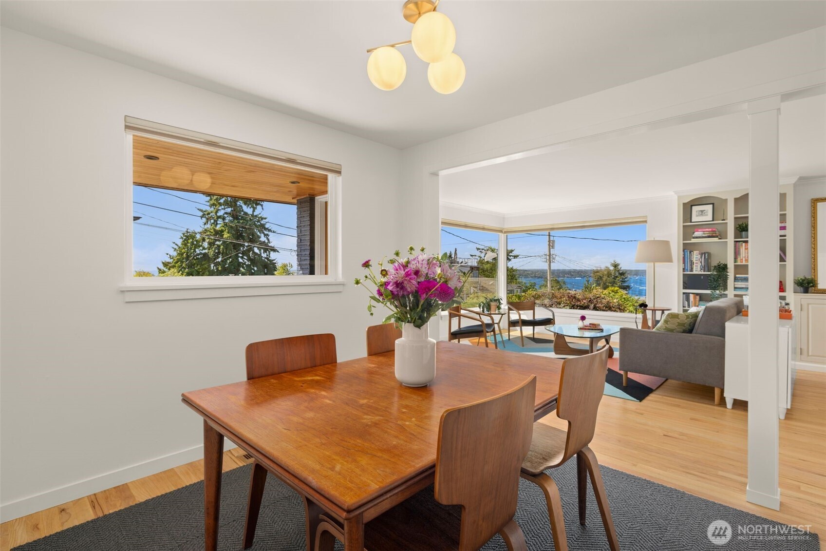 4110 Southwest Rose Street Seattle, WA 98136 - Photo 6 of 39 a dining room with furniture potted plants and wooden floor
