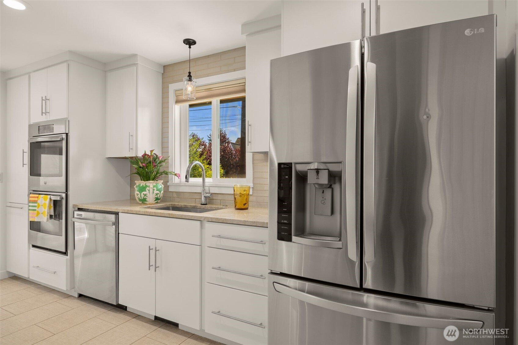 4110 Southwest Rose Street Seattle, WA 98136 - Photo 10 of 39 a kitchen with appliances a refrigerator and cabinets