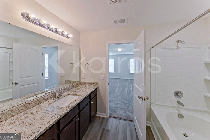 105 Bluff Road Springfield, GA 31329 - Photo 17 of 21 a spacious bathroom with a granite countertop double vanity sink a mirror and shower