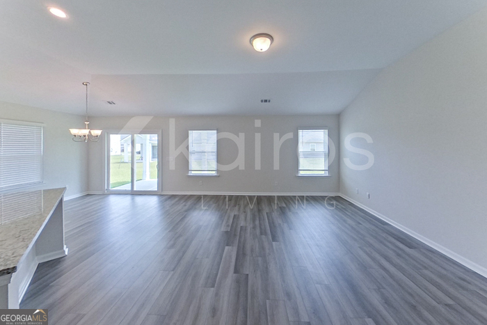 105 Bluff Road Springfield, GA 31329 - Photo 2 of 21 an empty room with wooden floor and windows