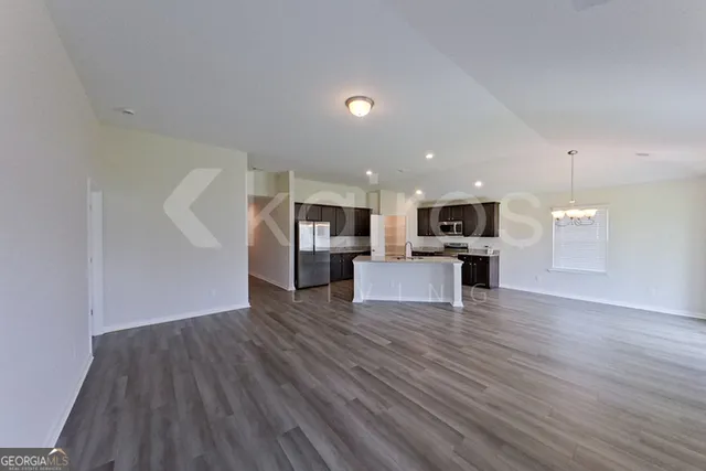 a view of kitchen with furniture and wooden floor