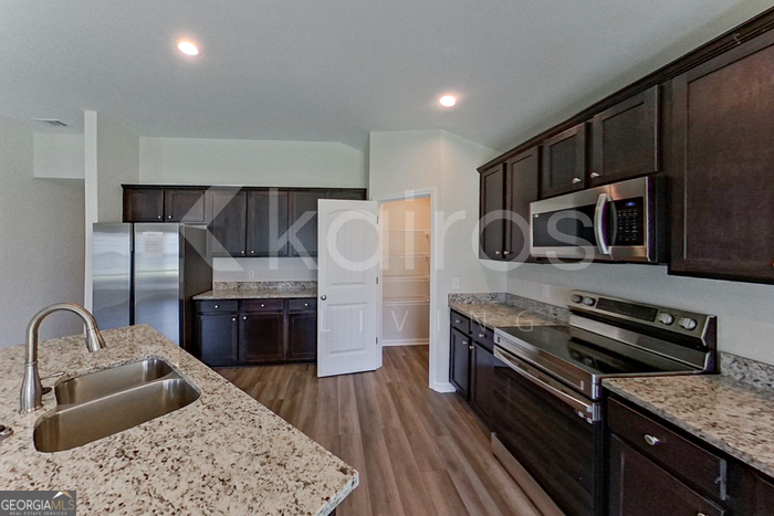 105 Bluff Road Springfield, GA 31329 - Photo 5 of 21 a kitchen with stainless steel appliances granite countertop a refrigerator stove and sink