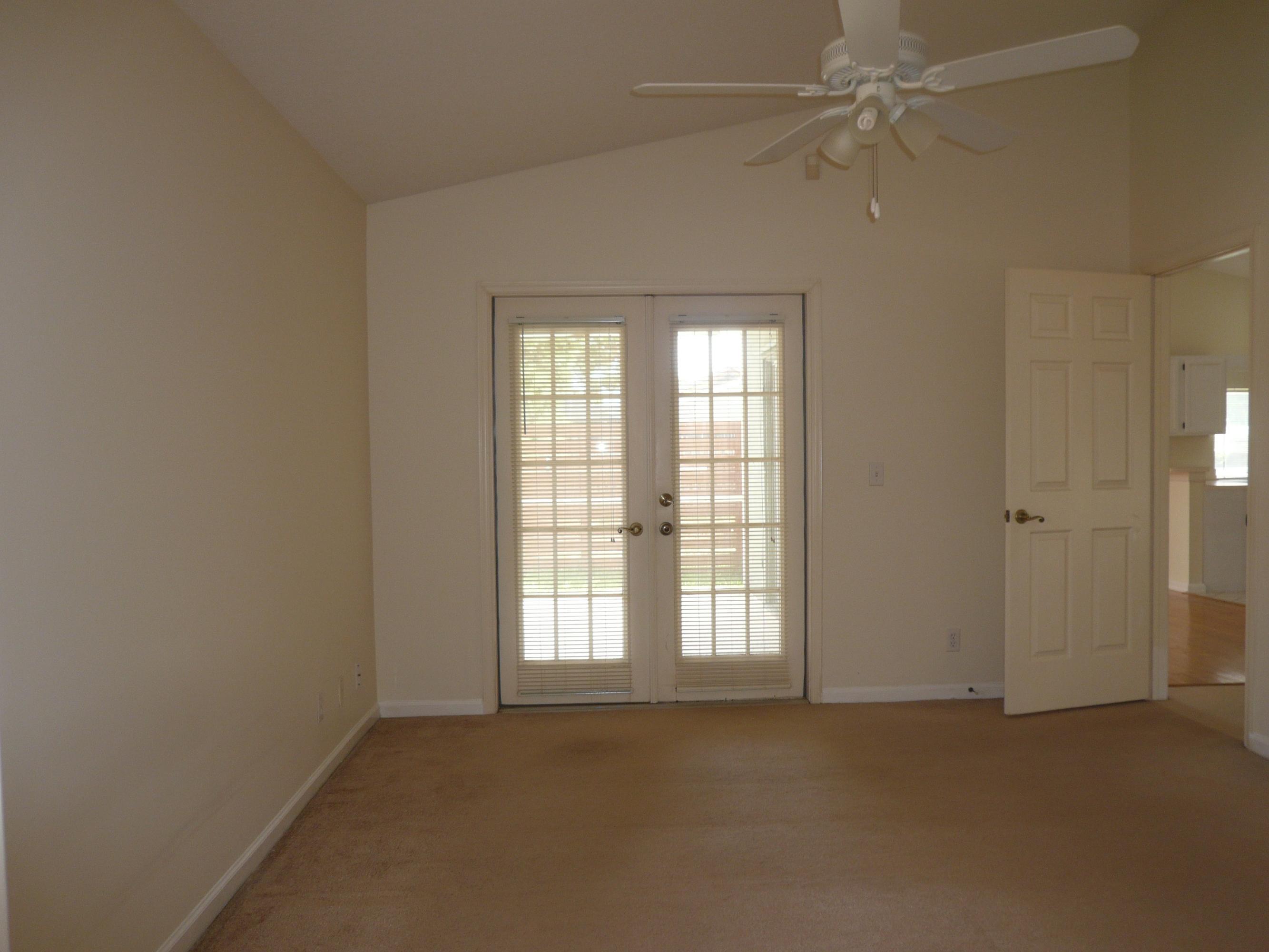 6287 Garrett Street Jupiter, FL 33458 - Photo 11 of 17 an empty room with a window and a fan