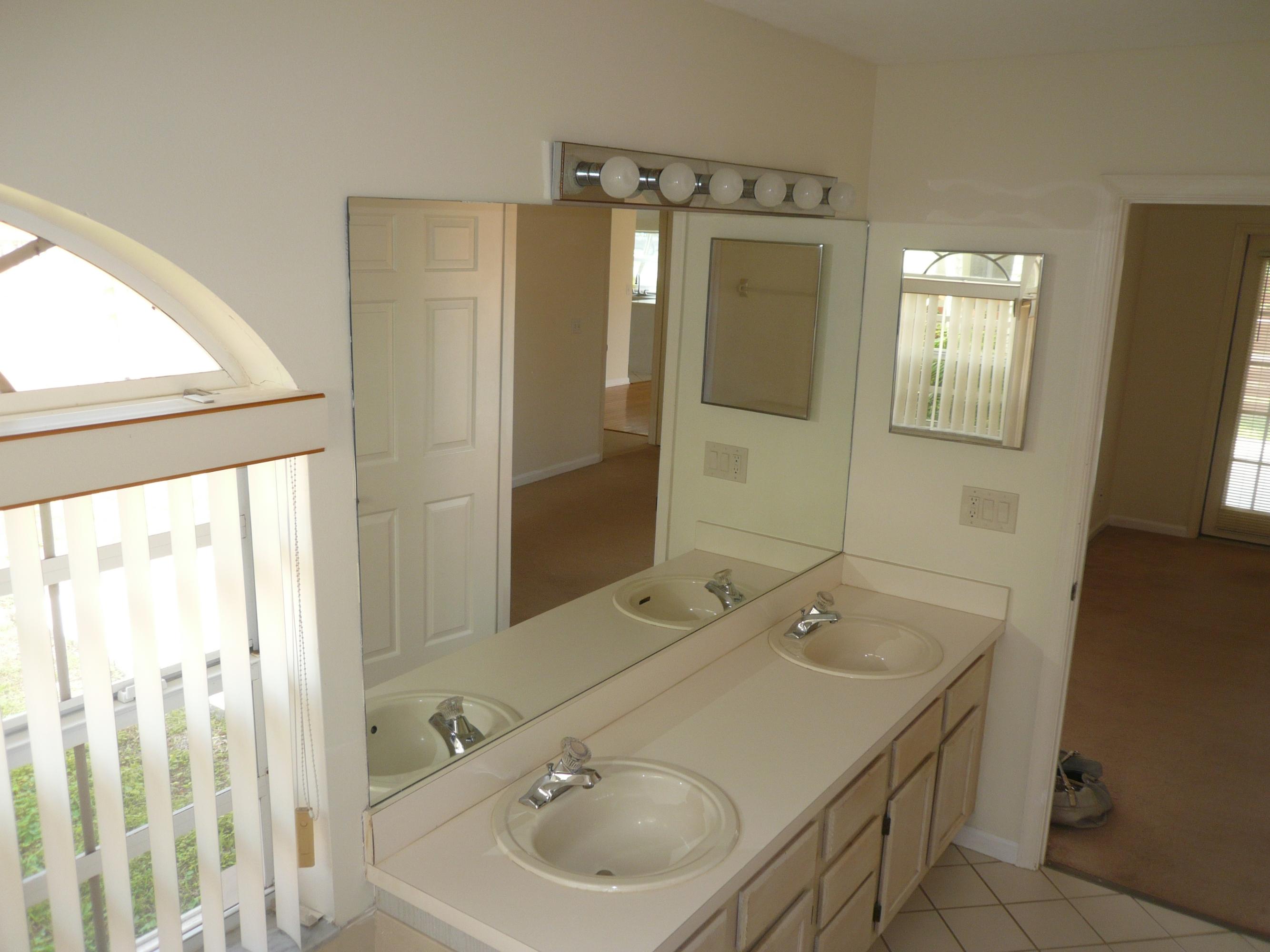 6287 Garrett Street Jupiter, FL 33458 - Photo 13 of 17 a bathroom with a sink and a mirror