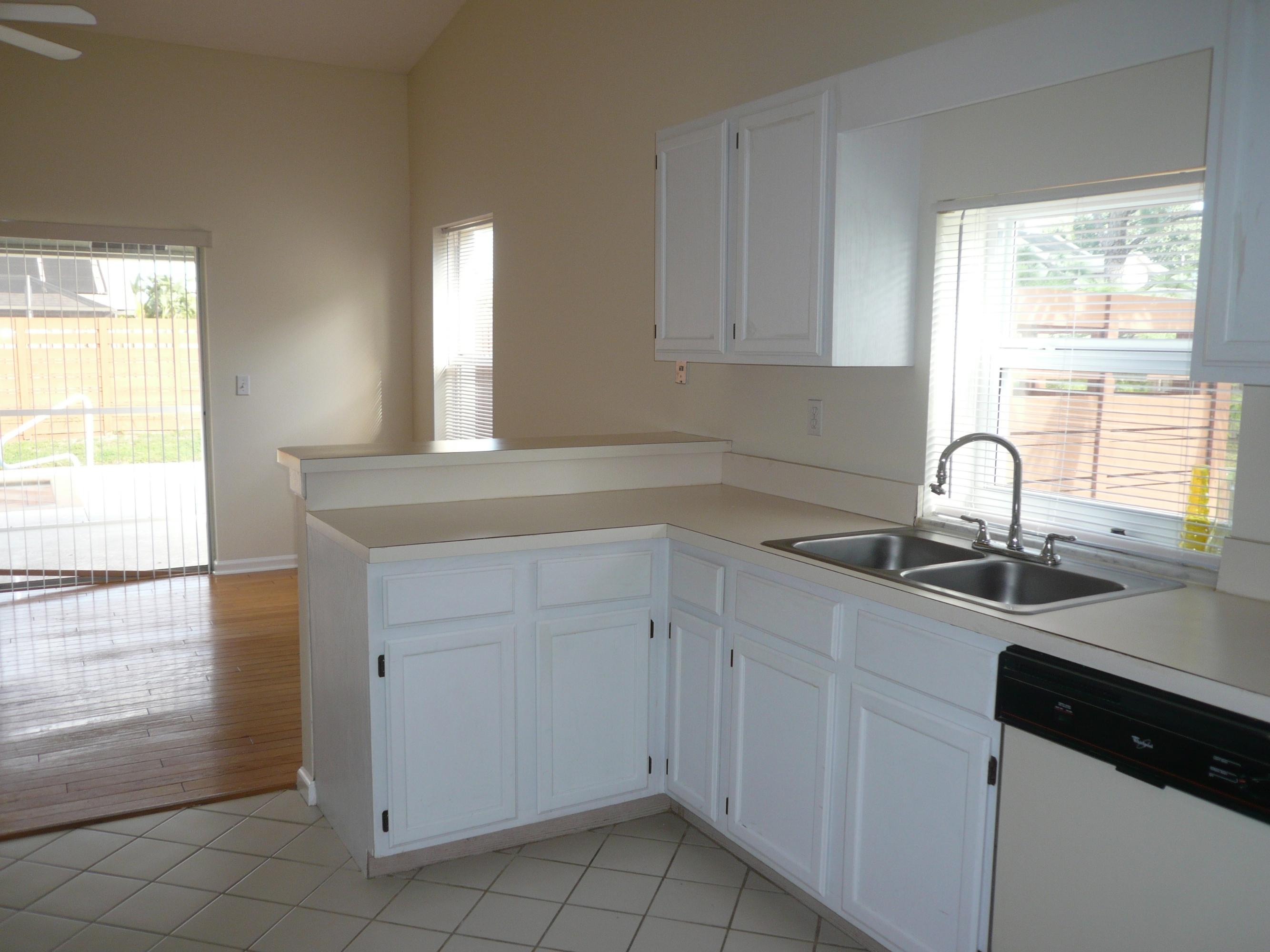 6287 Garrett Street Jupiter, FL 33458 - Photo 7 of 17 a kitchen with a sink and cabinets