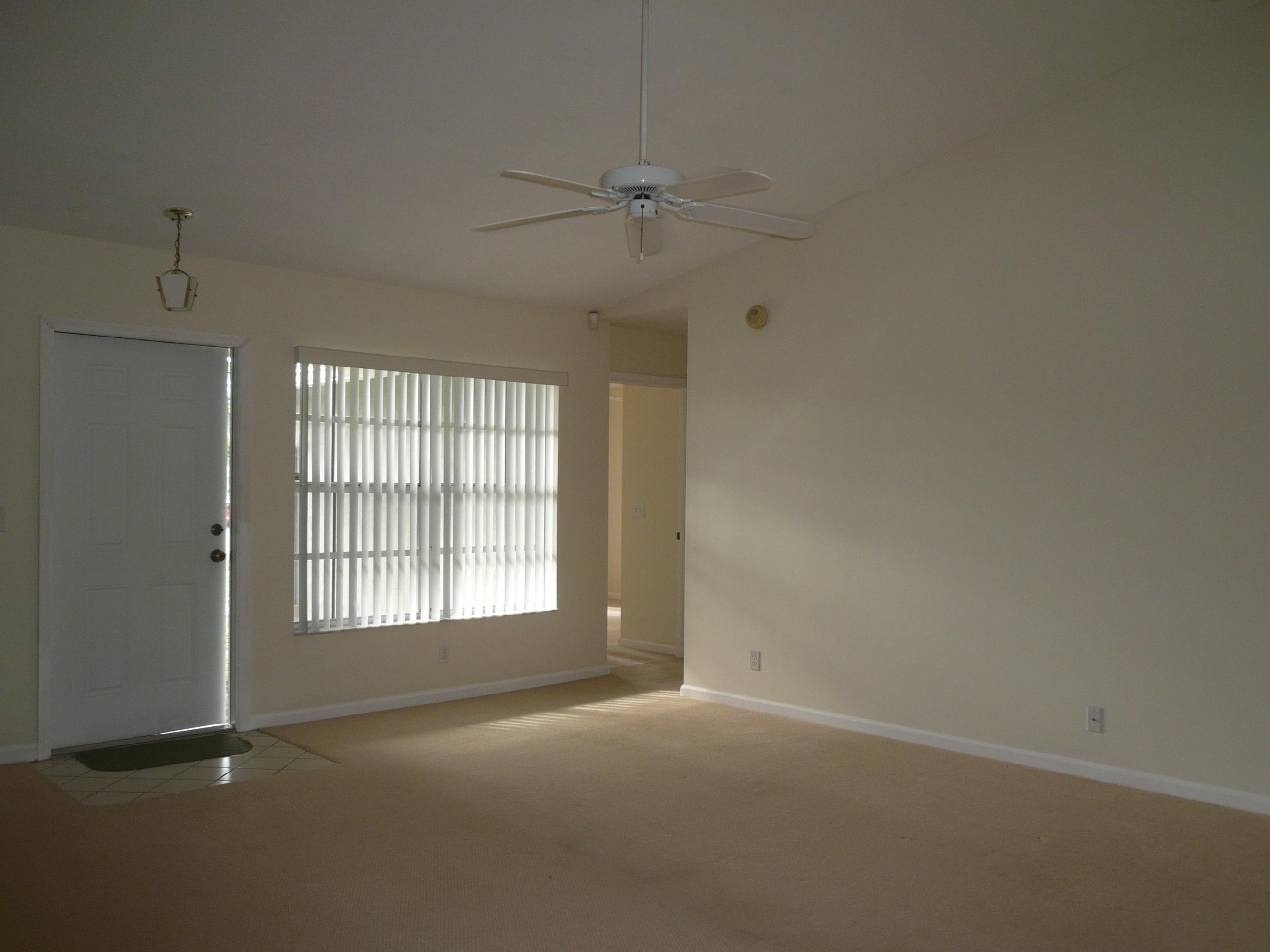 6287 Garrett Street Jupiter, FL 33458 - Photo 10 of 17 an empty room with a empty space and windows