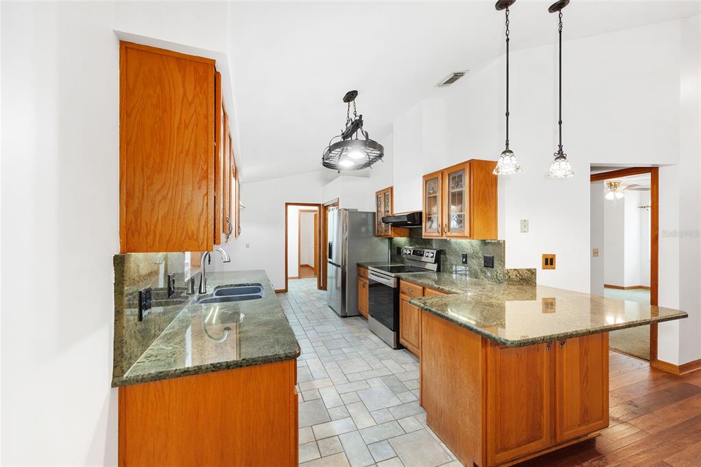 12861 Southwest 45th Lane Road Ocala, FL 34481 - Photo 17 of 73 a kitchen with a sink stove and refrigerator