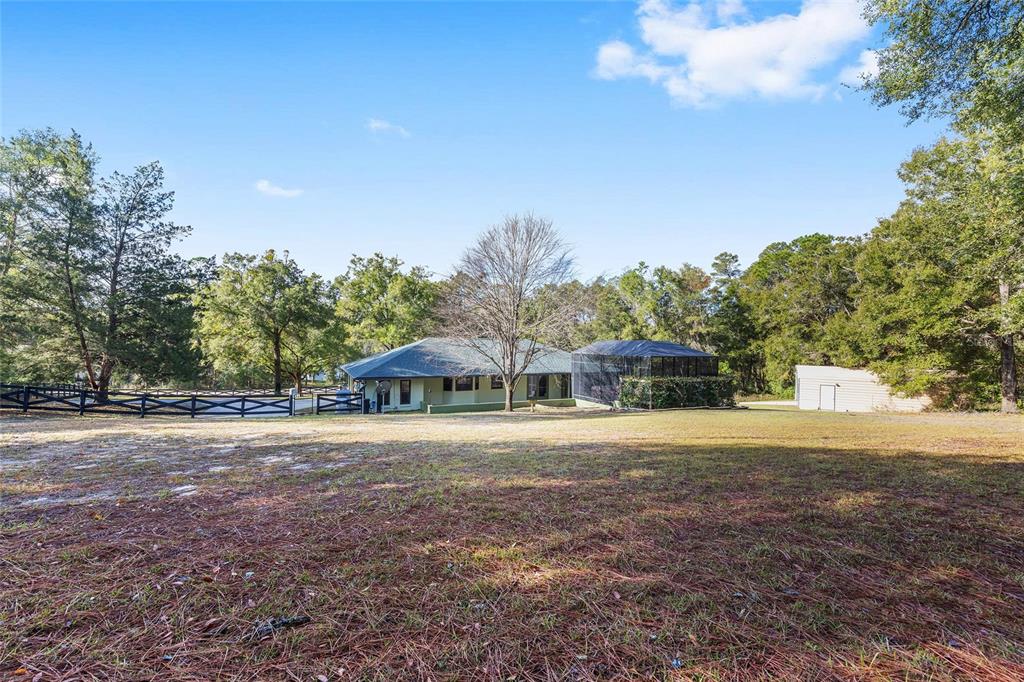12861 Southwest 45th Lane Road Ocala, FL 34481 - Photo 50 of 73 a house with trees in the background