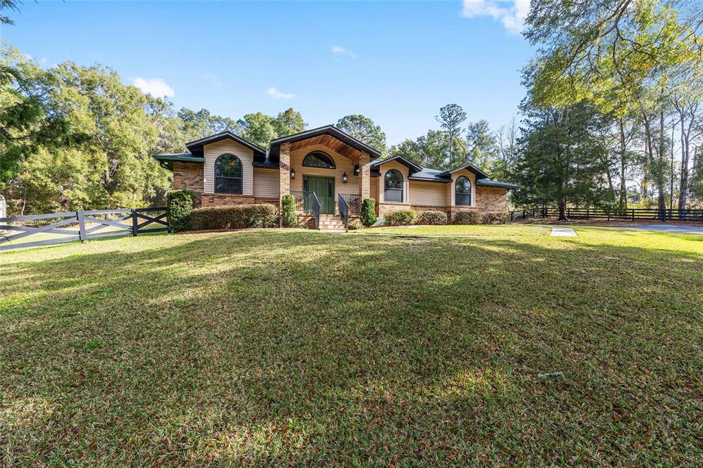 12861 Southwest 45th Lane Road Ocala, FL 34481 - Photo 5 of 73 a front view of a house with a yard