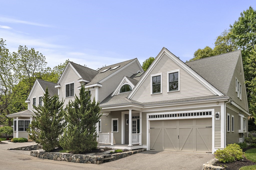 a view of a white house with a potted plant and a large window