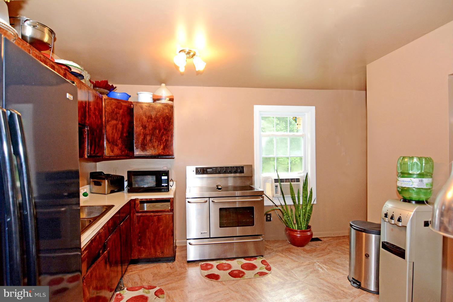 1247 Bacon Ridge Road Crownsville, MD 21032 - Photo 9 of 24 Kitchen with Stainless Appliances / Burl Cabinetry