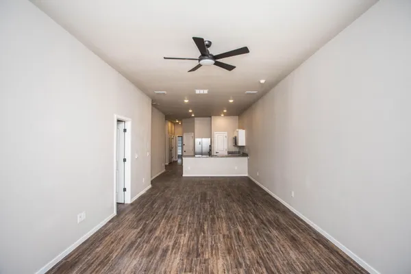 a view of a hallway with wooden floor