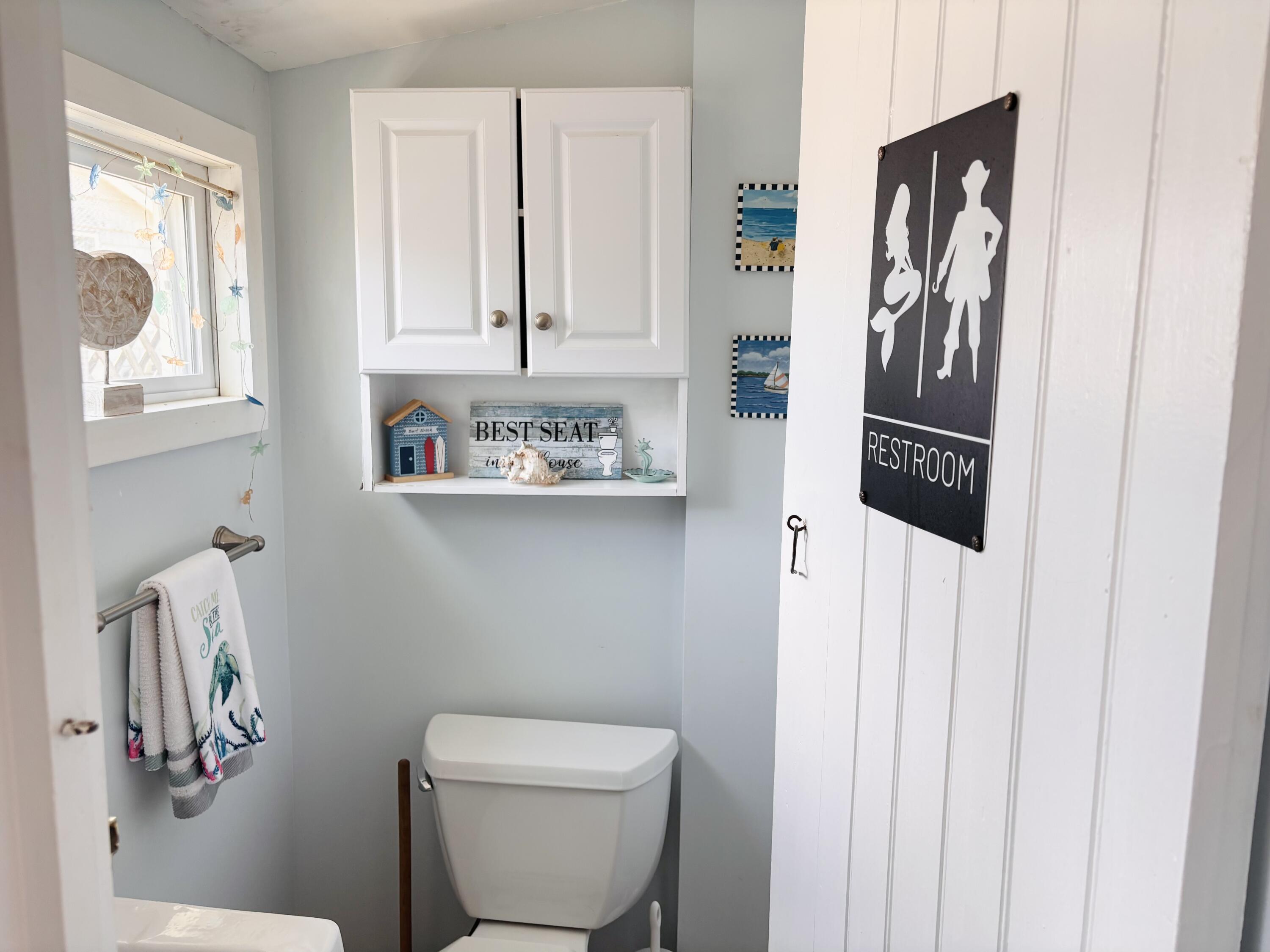 241 Old Wharf Road, Unit 91 Dennis Port, MA 02639 - Photo 11 of 16 a bathroom with a toilet sink and mirror
