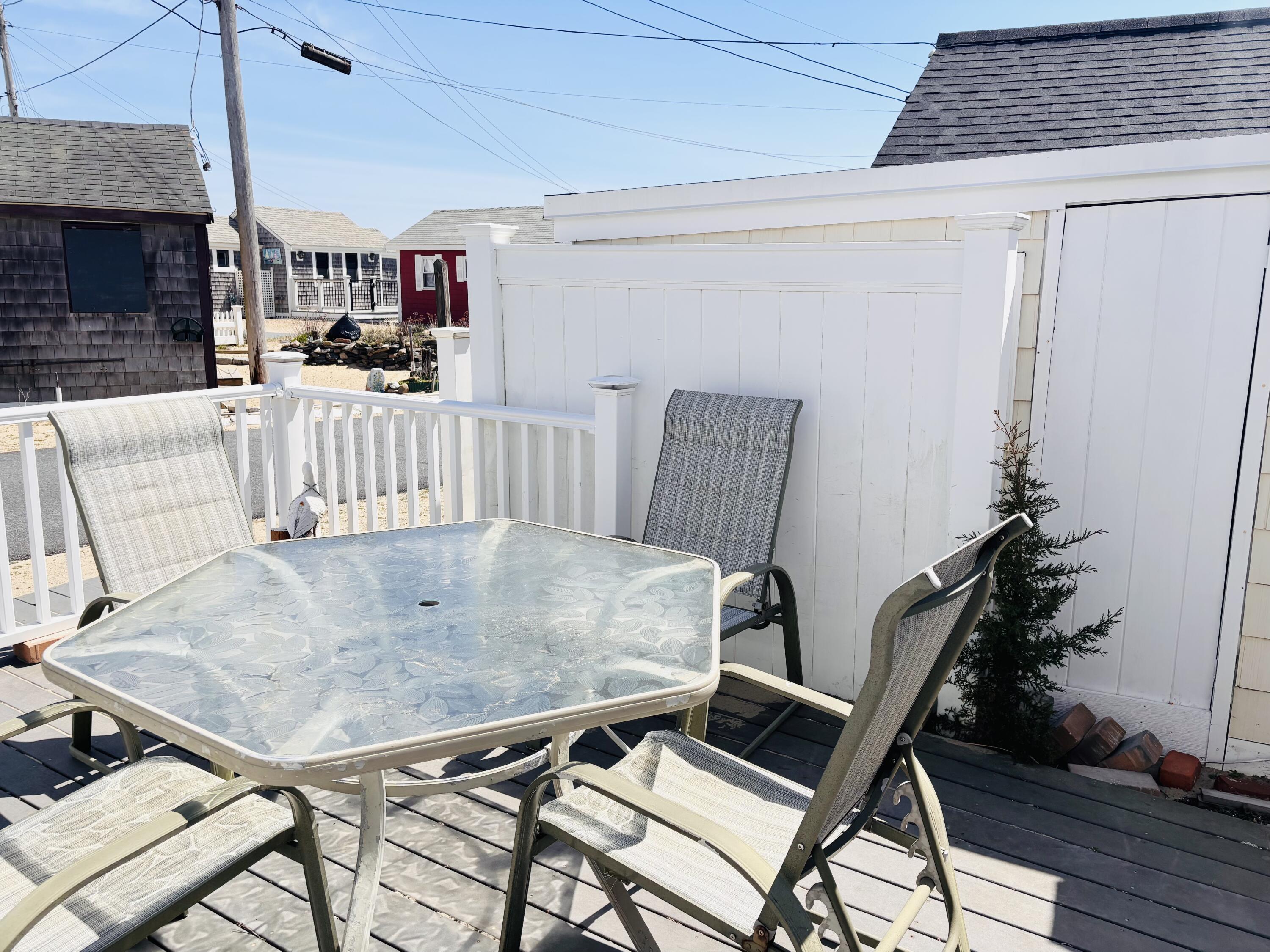 241 Old Wharf Road, Unit 91 Dennis Port, MA 02639 - Photo 3 of 16 a dining room with furniture and wooden floor