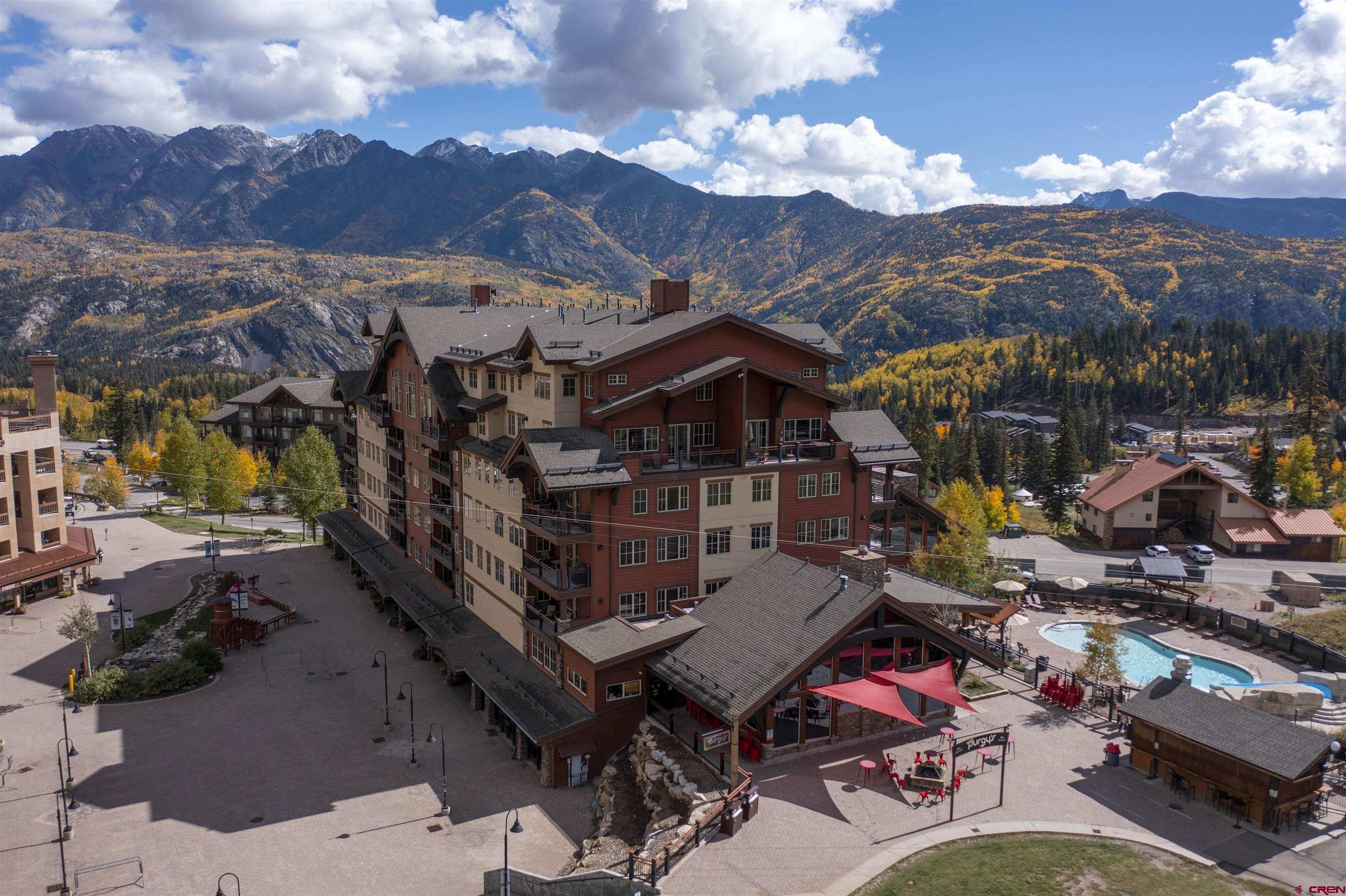 a roof deck with table and chairs