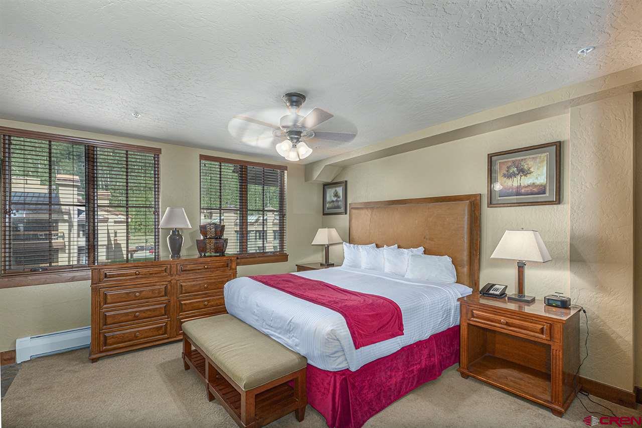 24 Sheol Street, Unit 504 Durango, CO 81301 - Photo 19 of 30 a bedroom with a bed and wooden floor