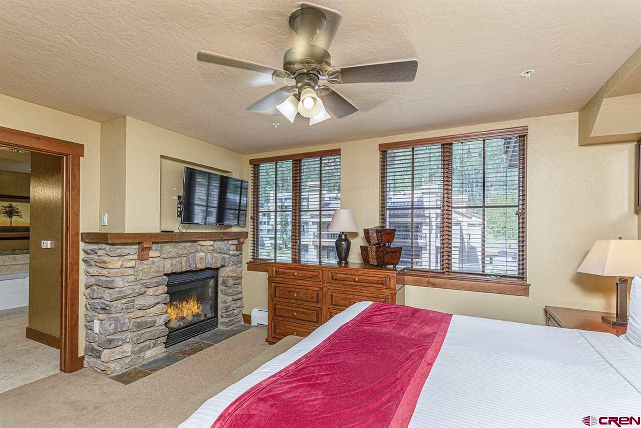 24 Sheol Street, Unit 504 Durango, CO 81301 - Photo 20 of 30 a bedroom with a bed and a fireplace