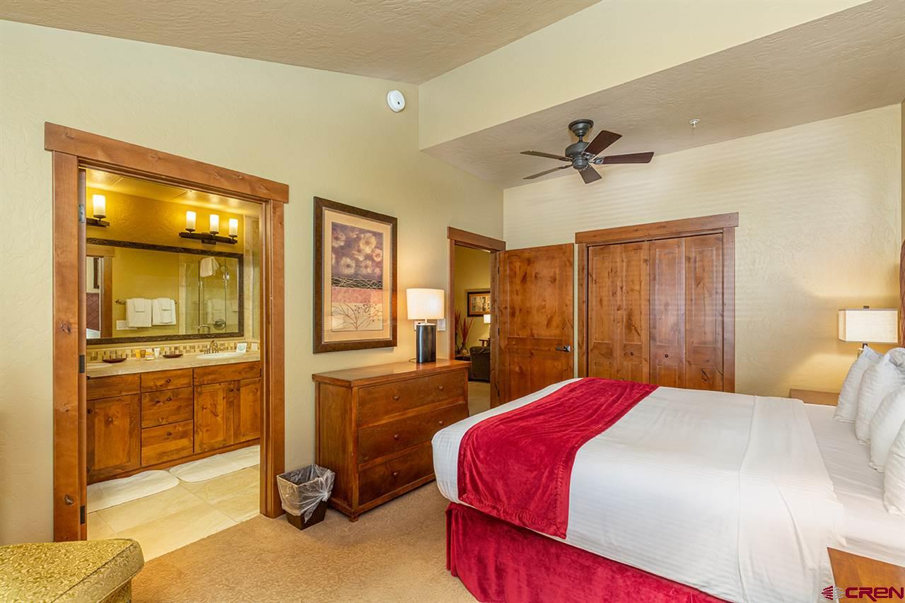 24 Sheol Street, Unit 504 Durango, CO 81301 - Photo 21 of 22 a bedroom with a bed and a chandelier