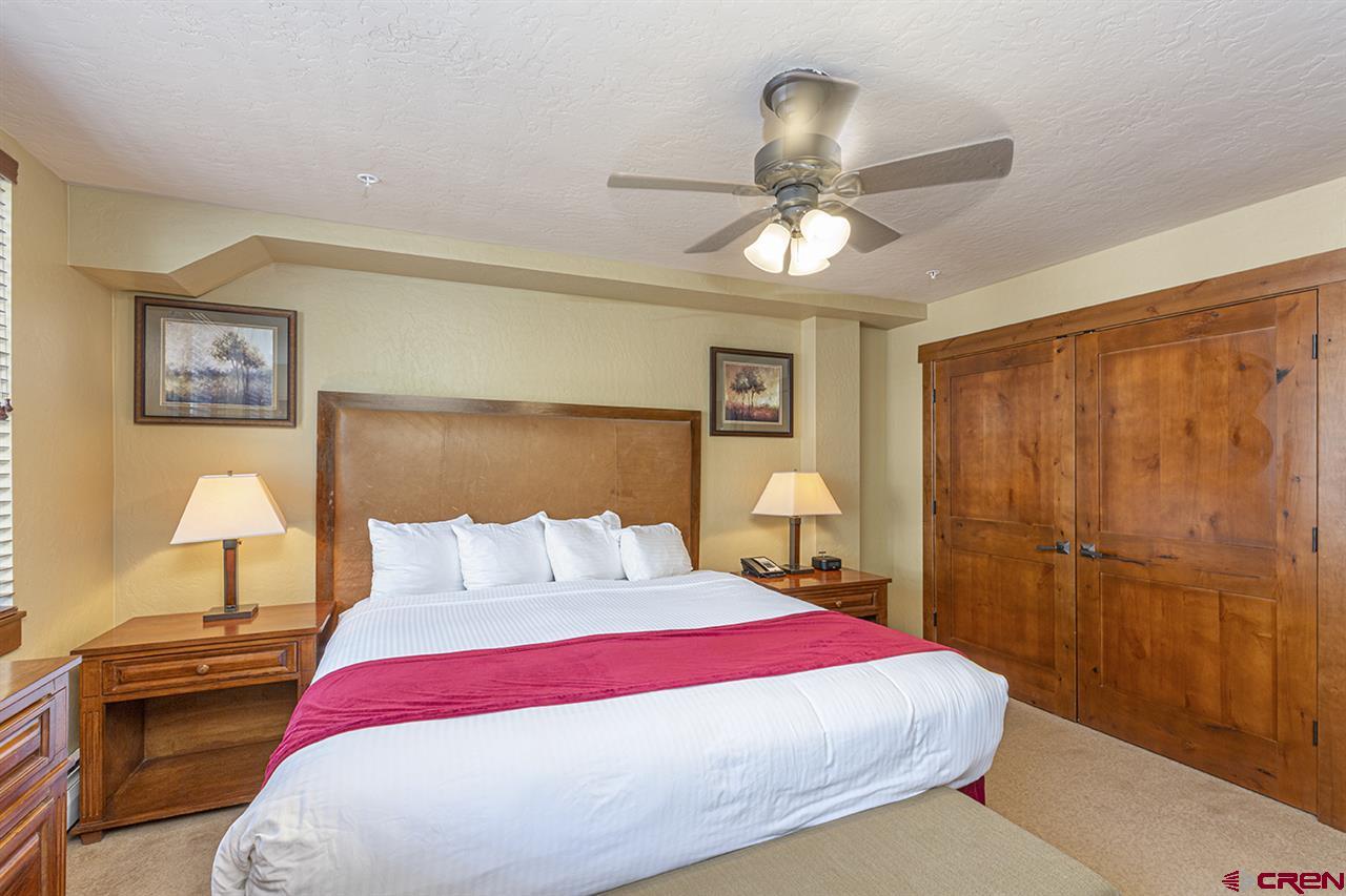 24 Sheol Street, Unit 504 Durango, CO 81301 - Photo 21 of 30 a bedroom with a bed and a chandelier