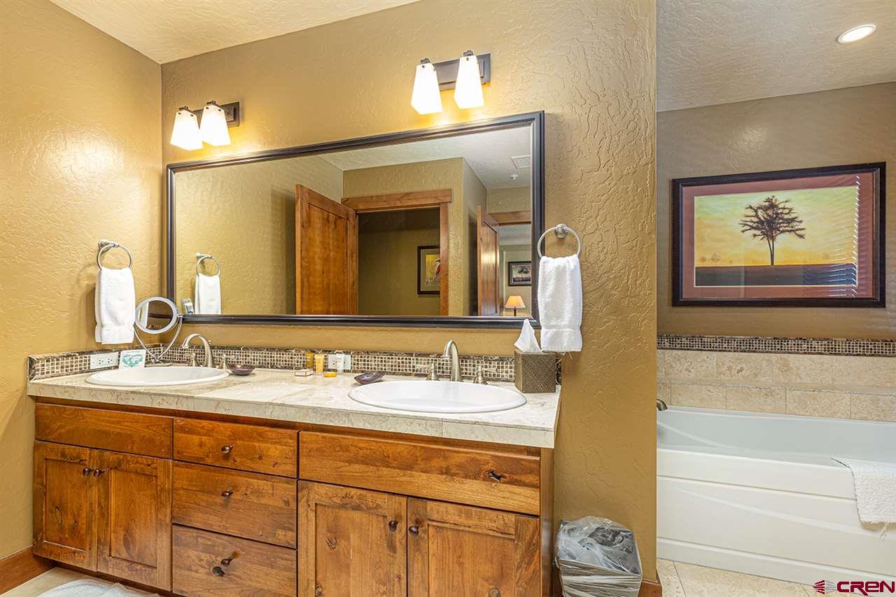 24 Sheol Street, Unit 504 Durango, CO 81301 - Photo 23 of 30 a bathroom with a double vanity sink and a mirror