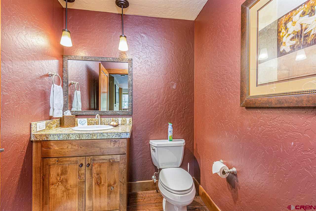 24 Sheol Street, Unit 504 Durango, CO 81301 - Photo 26 of 30 a bathroom with a granite countertop toilet sink and mirror