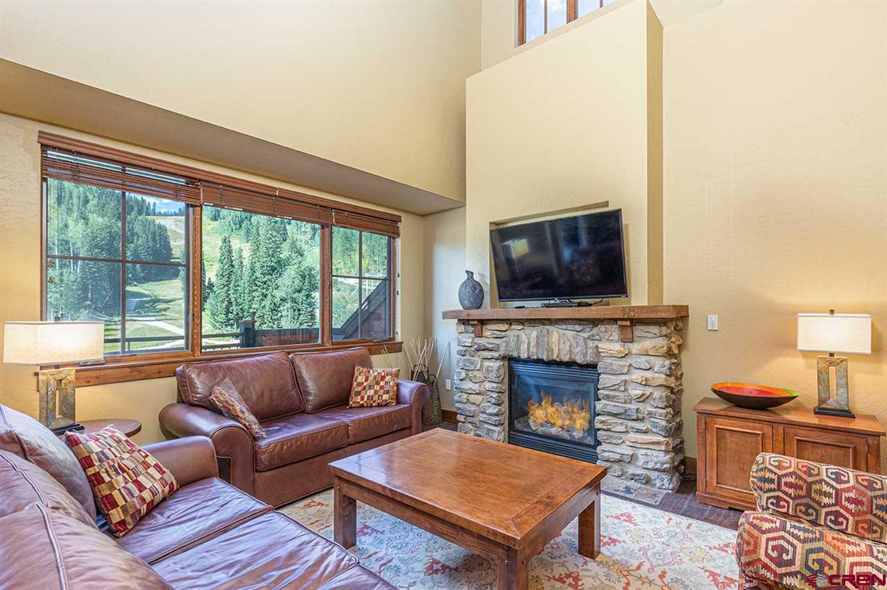 24 Sheol Street, Unit 504 Durango, CO 81301 - Photo 5 of 22 a living room with furniture a large window and a fireplace