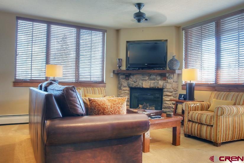 24 Sheol Street, Unit 504 Durango, CO 81301 - Photo 9 of 30 a living room with furniture flat screen tv and a fireplace