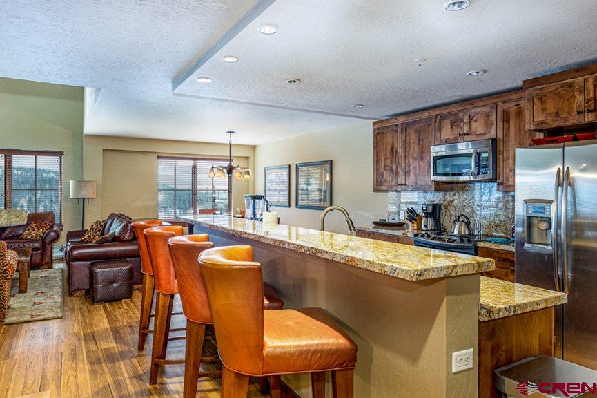 24 Sheol Street, Unit 504 Durango, CO 81301 - Photo 10 of 30 a dining table with chairs and kitchen view