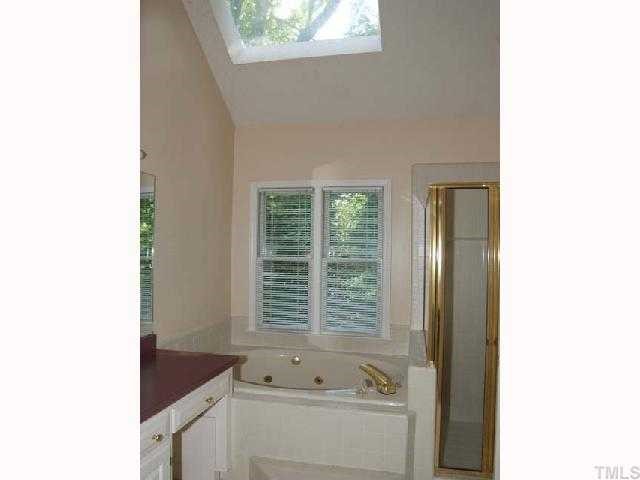 6804 Chasewick Circle Raleigh, NC 27615 - Photo 8 of 12 a bath room with a sink and a tub