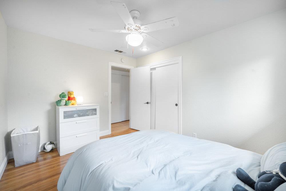 740 Roble Drive Morgan Hill, CA 95037 - Photo 19 of 43 a bedroom with a bed and a chandelier