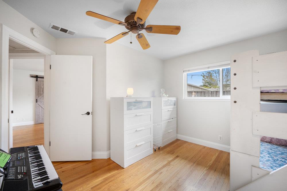 740 Roble Drive Morgan Hill, CA 95037 - Photo 21 of 43 a view of room with hardwood floor and a ceiling fan