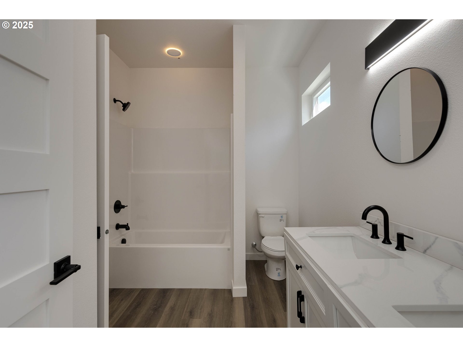 4801 Southeast Ina Avenue Milwaukie, OR 97267 - Photo 7 of 25 a bathroom with a sink a toilet and a mirror