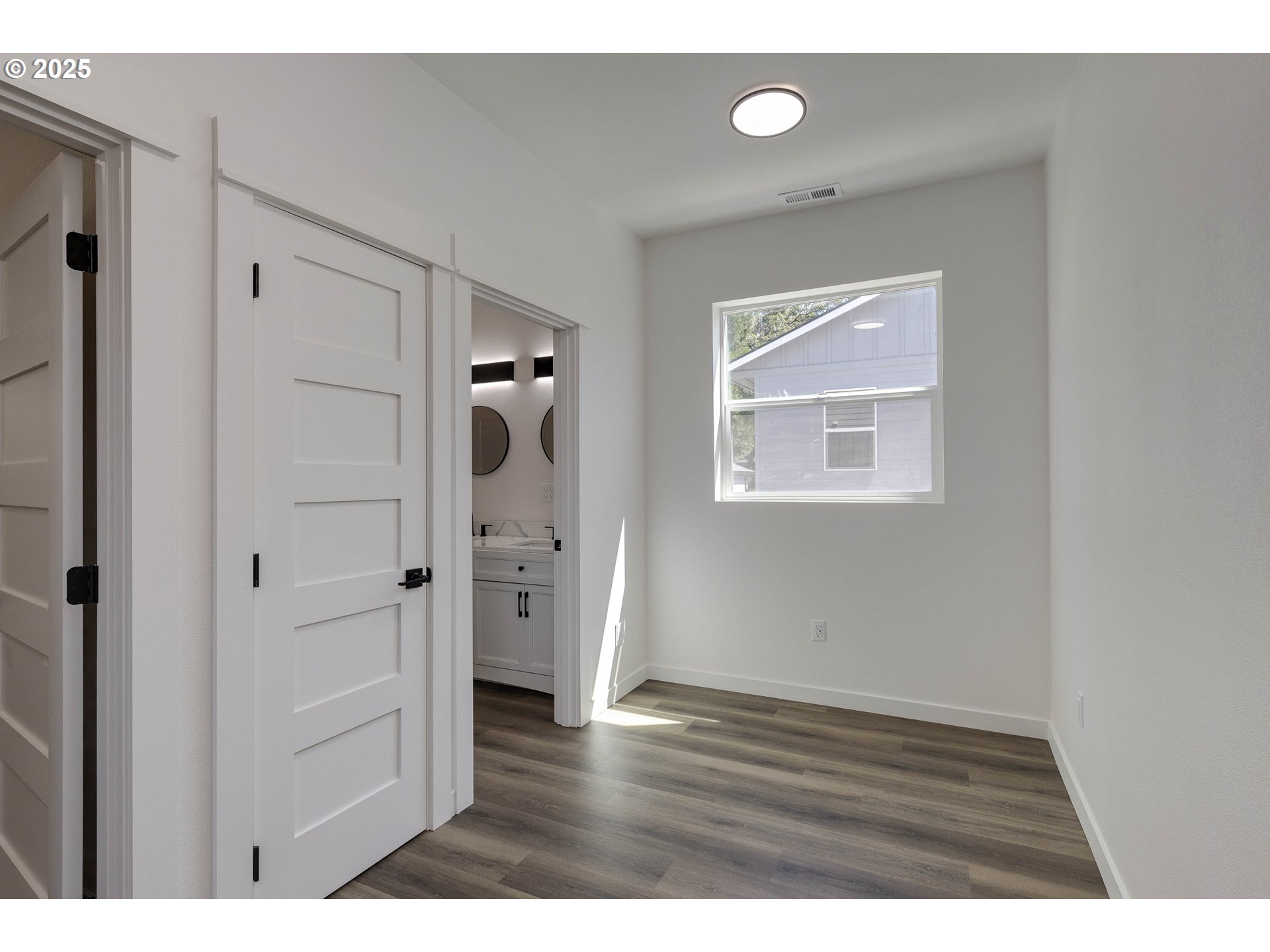 4801 Southeast Ina Avenue Milwaukie, OR 97267 - Photo 8 of 25 a view of an empty room with wooden floor and a bathroom