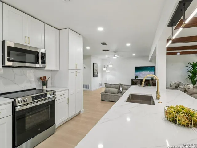 a spacious bedroom with a bed and a couch