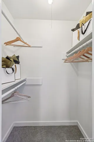 a bedroom with a large bed and a potted plant