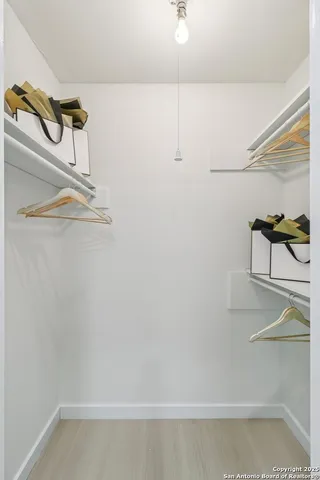 a bedroom with a bed and a potted plant