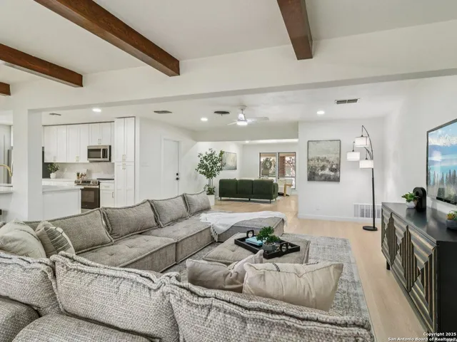 a living room with furniture and a large mirror