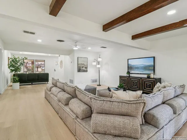 a kitchen with a dining table chairs and white cabinets